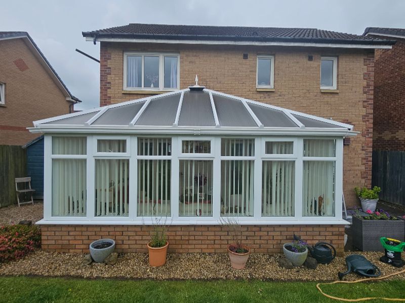 Clean conservatory with spotless glass roof and UPVC frames after professional cleaning in East Kilbride